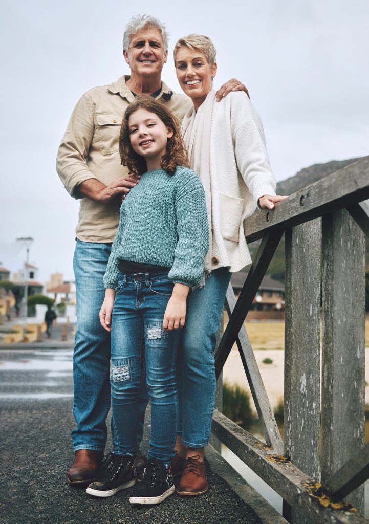 Portrait, child and grandparents on a bridge in a park for adven